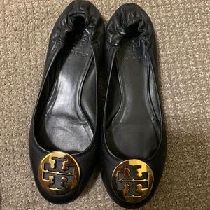 Tory Burch black with gold medallion.